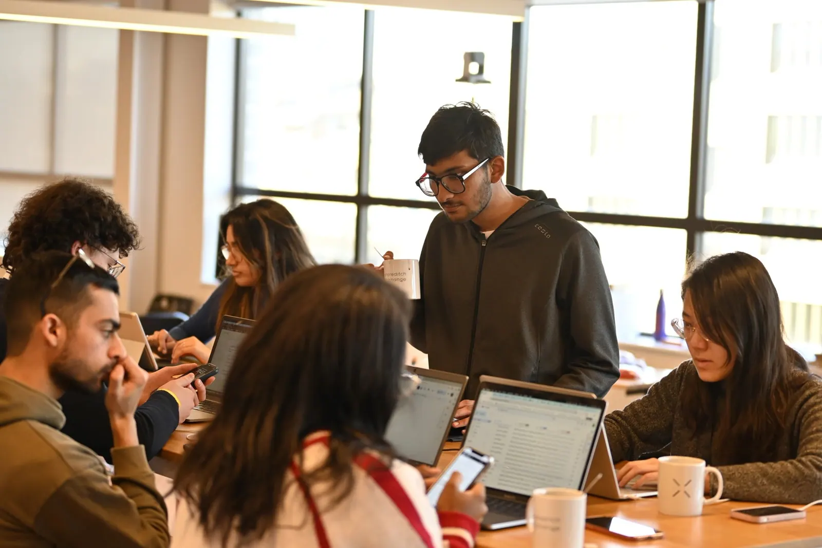 Hackathon participants working together on laptops