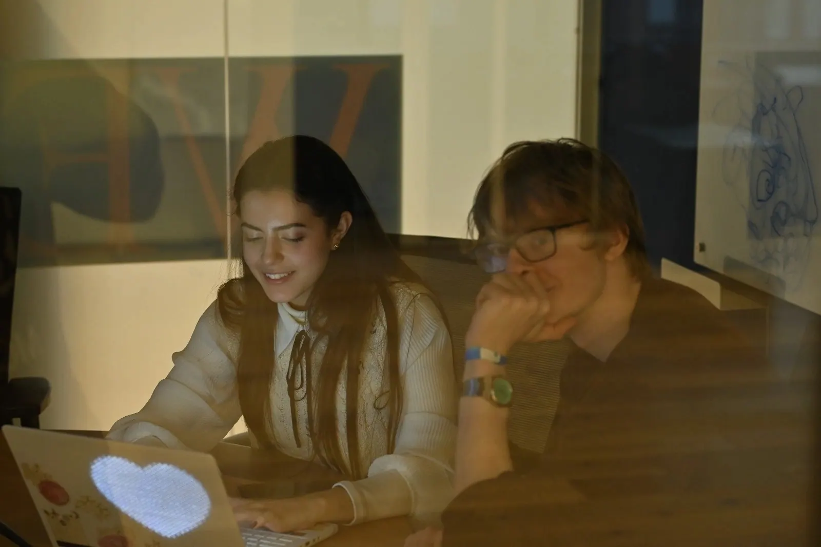 Two participants working late on a laptop