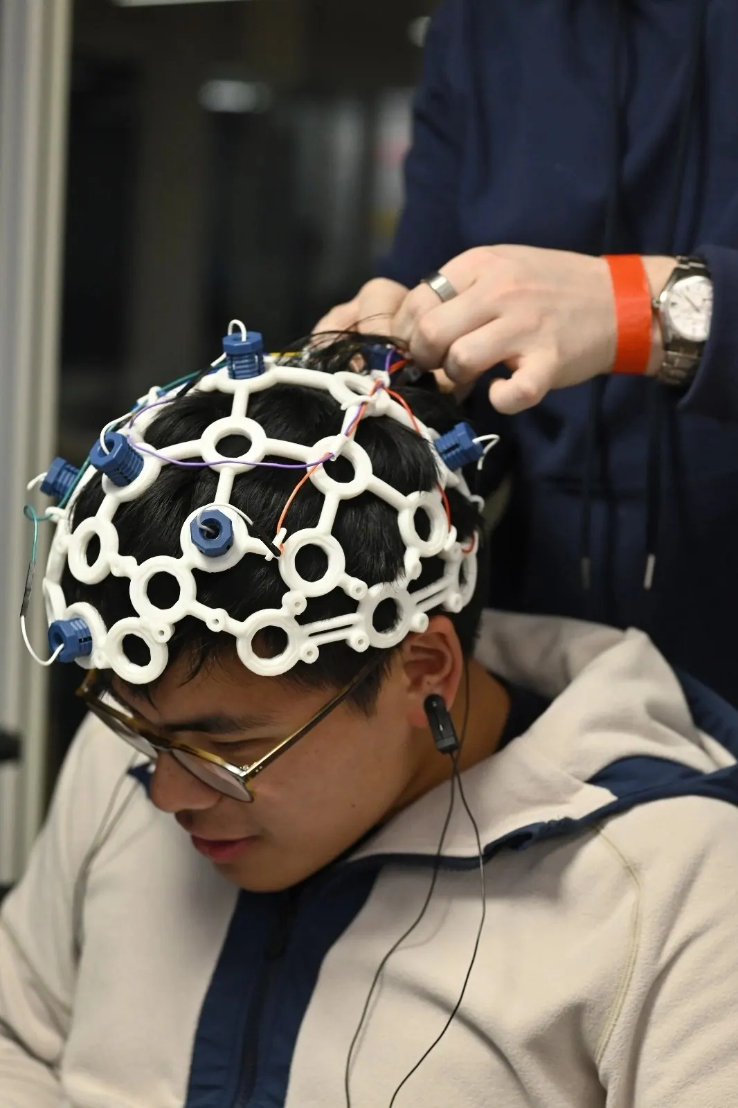 A participant being fitted with an EEG cap