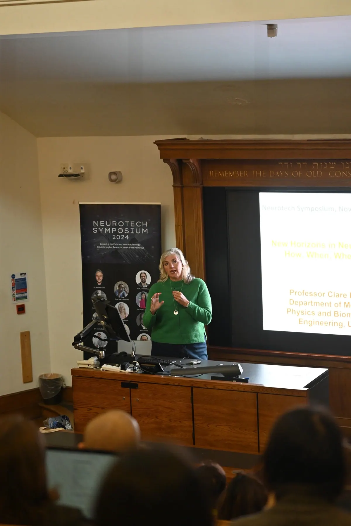 A speaker presenting at a lectern in a lecture theatre