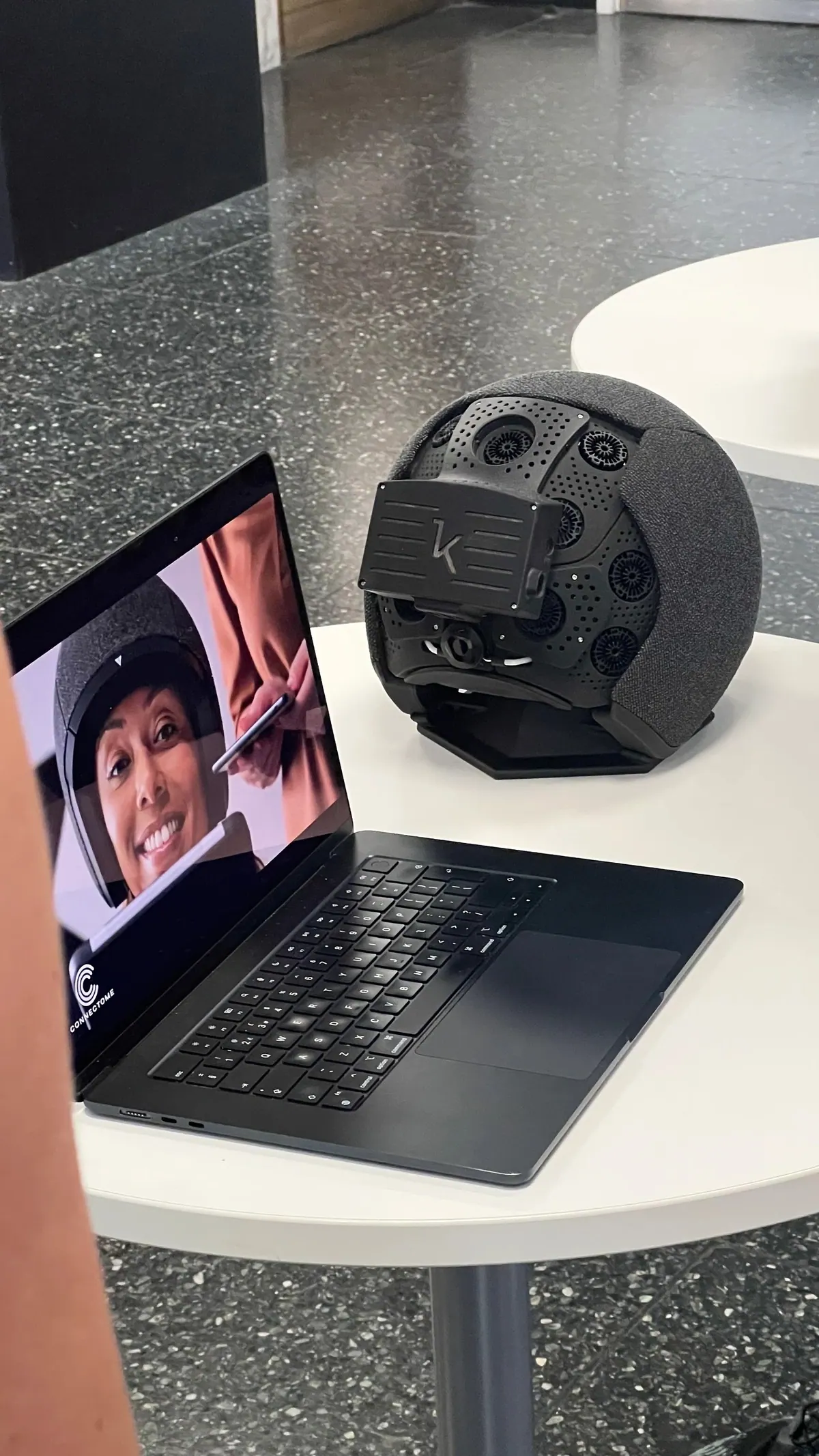 A speaker joining remotely on a laptop beside a hardware device