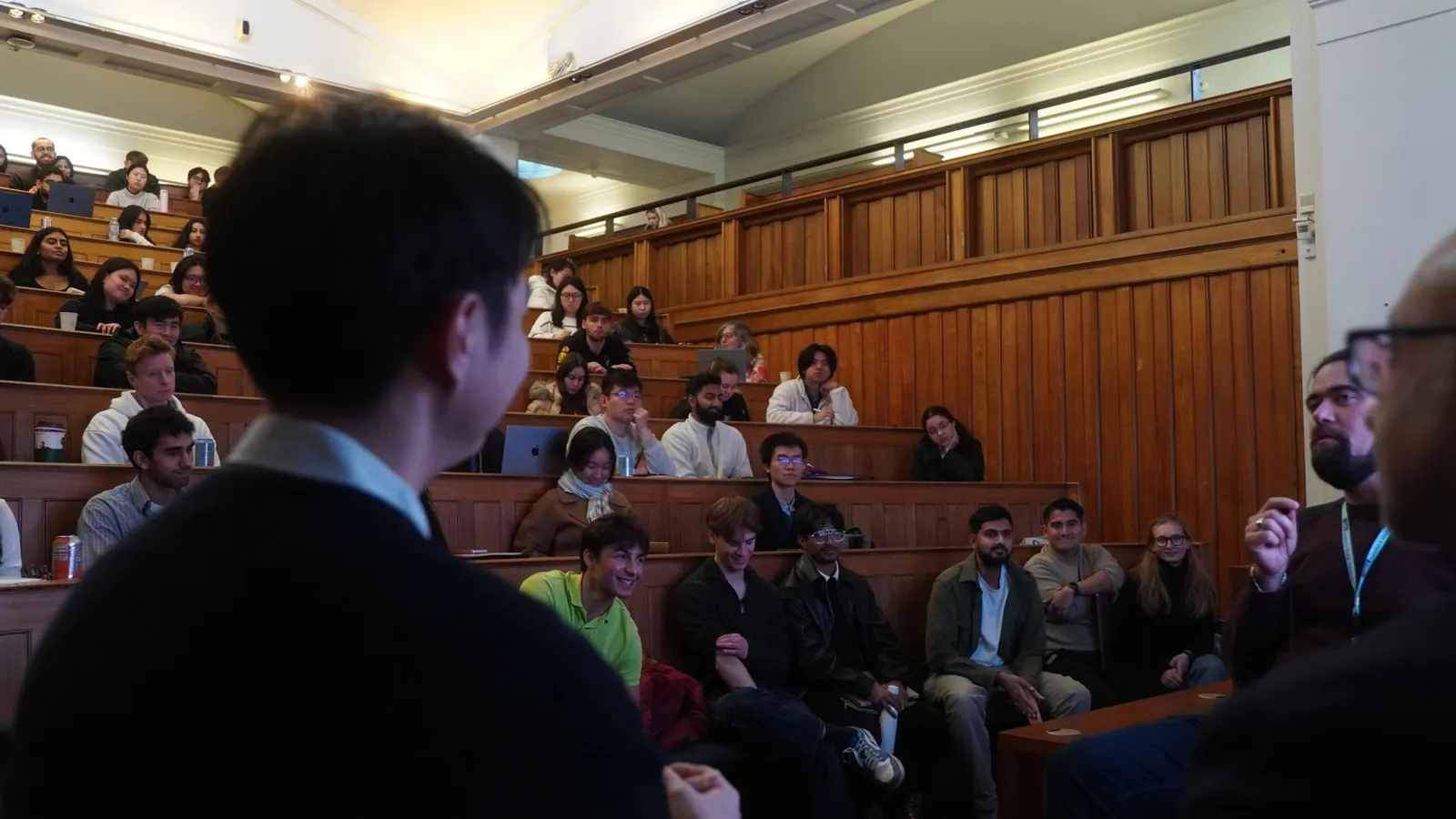 Audience in a tiered lecture theatre facing the speaker